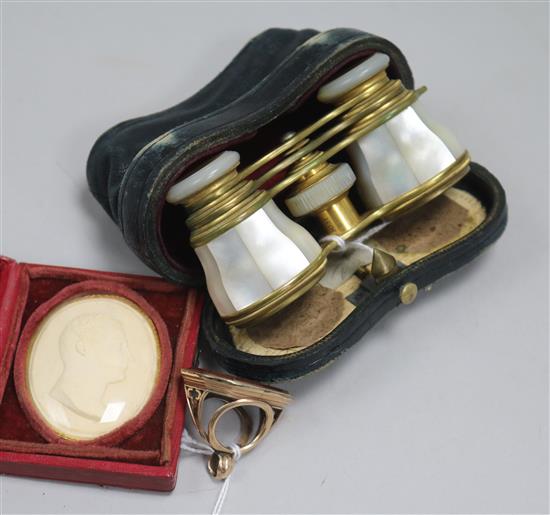 A 19th century pinchbeck fob seal with carnelian matrix, a pair of mother of pearl opera glasses and a plaster bust plaque